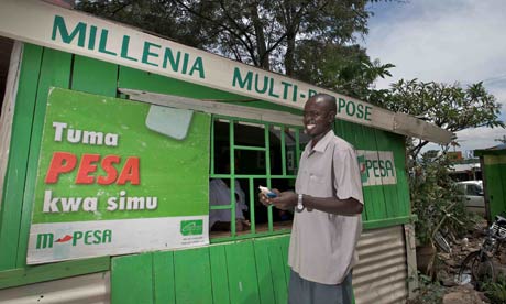 A man withdrawing money from an M-Pesa stall