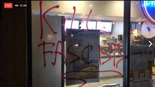 Berkeley protesters left  graffiti calling cards on windows of buildings.   