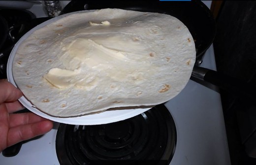 slide paper plate underneath, lift out of pan, cover with 2nd plate, flip over and return to pan