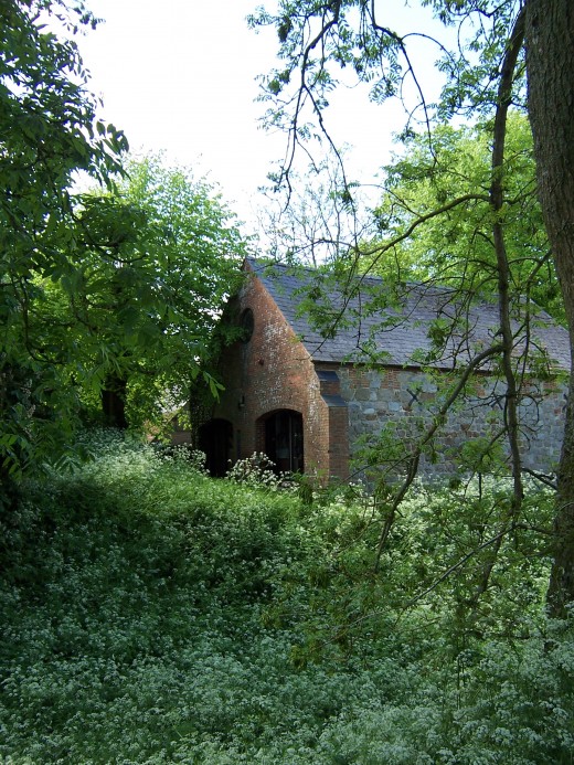 A restored structure caught from a pathway in Avebury, England.