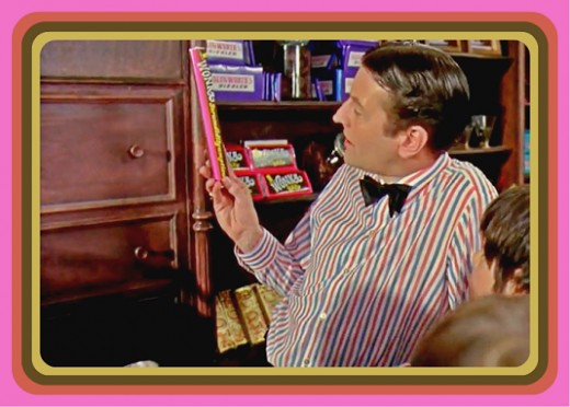 Bill played by Aubrey Woods shows the children Willy Wonka's new invention the Scrumdiddlyumptious chocolate bar