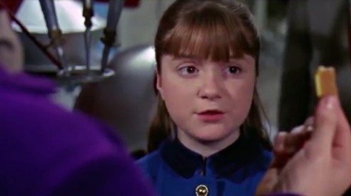 Violet Beauregarde eyes the 3 meal gum that Willy Wonka shows to his guests.
