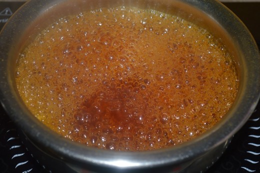 turmeric, coriander seeds, cinnamon and peppercorns inside the boiling water