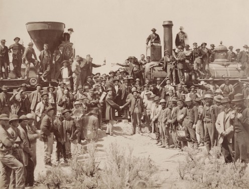 The eastern and western groups of workers meet and shake hands during the driving of the "last spike" into the railroad at Promontory Summit, Utah, in 1869.