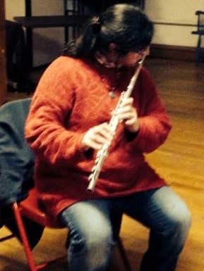 Seafarer Mama playing flute at an open mic