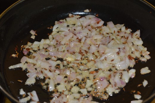 Step three: Add chopped onion and continue the sauteing