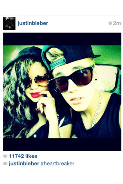 Justin posts a picture of the couple on July 4, but Selena, when approached by the media, denies any rumors of being back together with him and claims to be single. Explains Bieb's caption. #heartbreak.