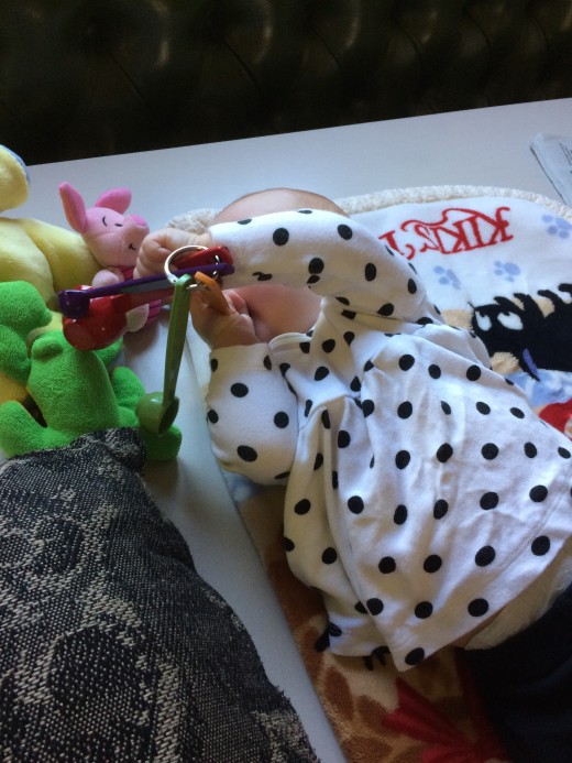 Imogen is now able to grab toys and bring them to her mouth.