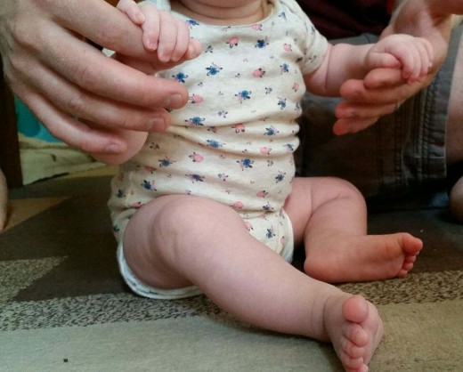Imogen loves sitting and needs only a bit of help for stabilization. As she becomes more stable, she will be able to sit by herself for short, then longer periods of time.