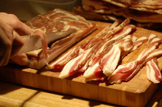 Homecured bacon being sliced