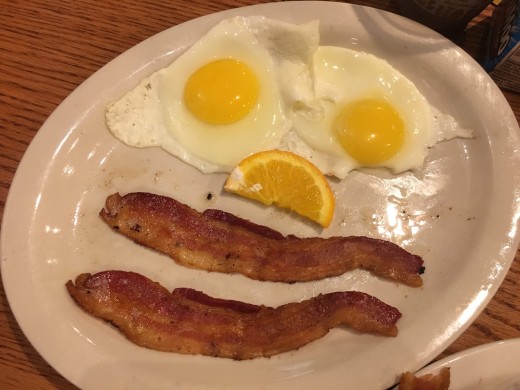 A breakfast made with bacon and eggs makes everyone smile.