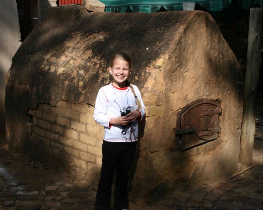 Caitlin in front of the old oven in the yard