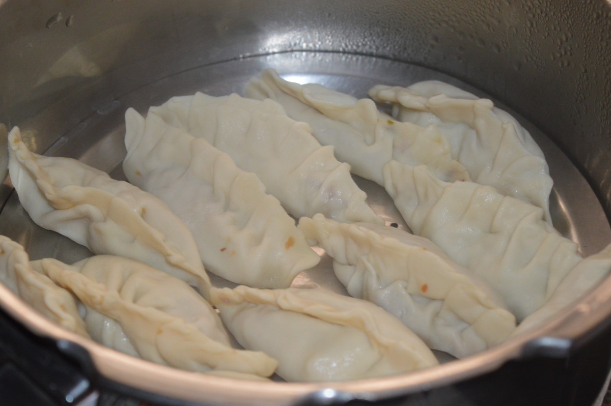 Step six: Heat the steamer with water. Let the steam start to come out. Place the greased perforated plate in the steamer/cooker. Place the dumplings one near the other. Steam cook for 6-7 minutes on high fire. Next, turn off the heat.
