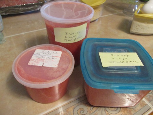 Pureed tomatoes placed in containers to be frozen.