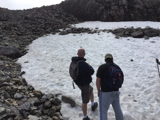Rob and Steve pondering why the snow might not have thawed. Generally the summit is only clear of foul weather in the high summer months.
