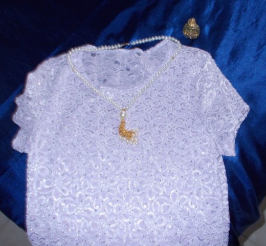Blouse, pearl necklace, perfume bottle from the author's wardrobe.