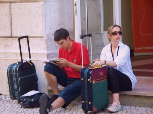 Without a plan, this couple arranges their stay in Lisbon, Portugal from th sidewalk.