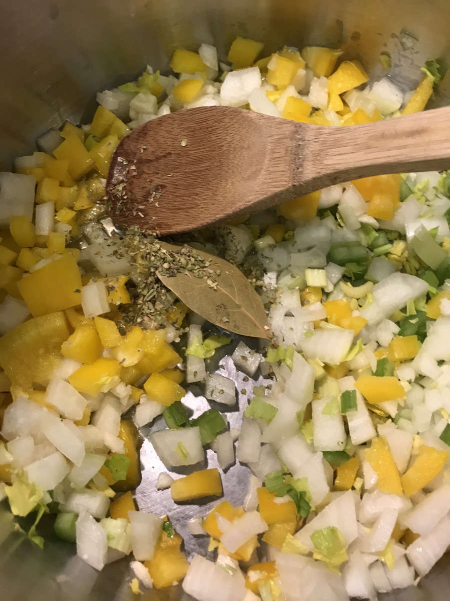 Onion, celery and bell pepper - the Cajun Trinity - starts the flavor base of this dish. Throw in some garlic, bay leaf, thyme, salt, pepper and red pepper flakes and you're good to go!