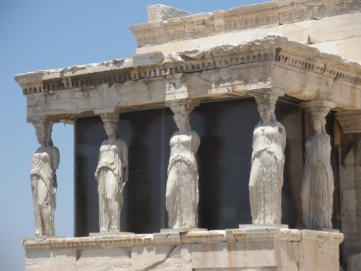 The Erechtheion. According to myth, Athena and Poseidon battled for patronage of Athens right there!  The design unites separate temples to each of the two gods.  