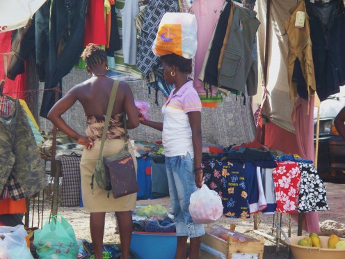 A West African market spreads over many streets and supplies fresh vegetables, clothing, and household items.