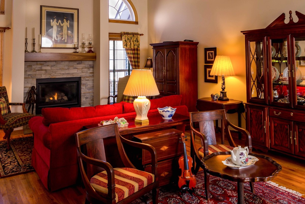 An attractive family room with antique wood furniture of cabinets and chairs. 