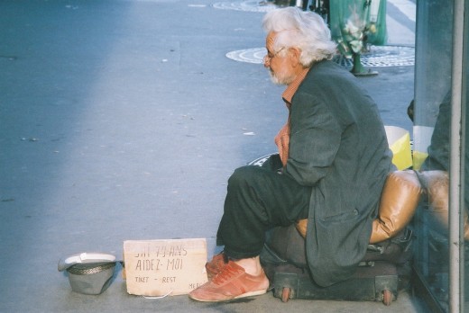 This was taken in Paris, France. The sign reads: "I am 79 years old. Help me."