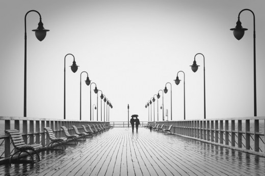 A Couple Walking Along a Pier