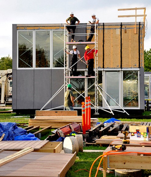 Modular home sections being assembled on-site.