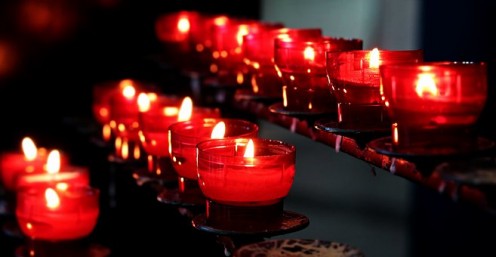 Lit up candle in a church