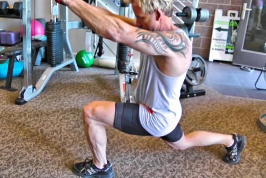 This is a photo of the author performing a lunge reverse wood chop. Movement happens in all three planes of motion, and it works on balance and coordination as well.