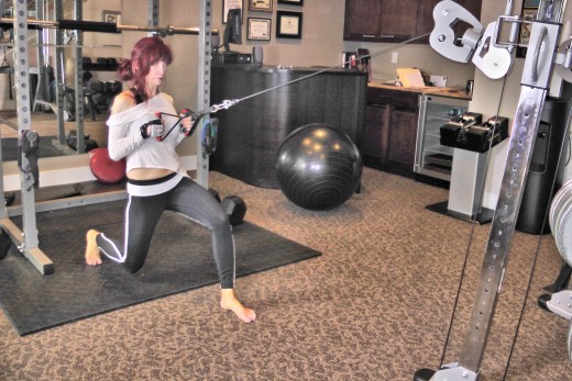 Sharon is performing a lunge pull. It works the upper back and the whole body in three planes of motion. I like having my clients do this right after a set of pull-downs do get a deeper burn in the lats and move the whole body.
