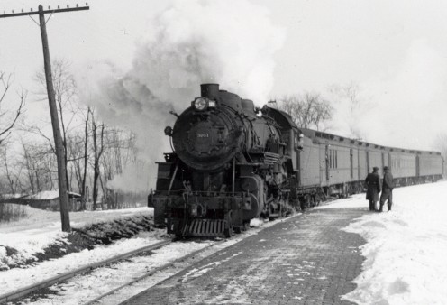 An early railroad locomotive and train.