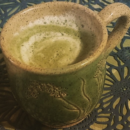 A glowing green tea latte, ready to savor.
