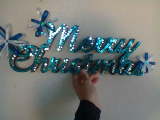 Light and dark blue sequence and ribbon Christmas sign. 