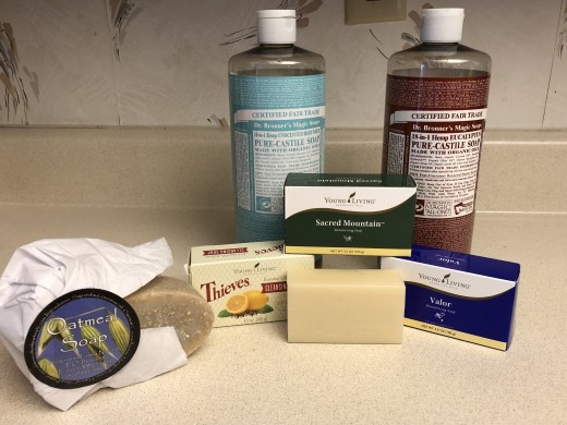 Bronner's Castile liquid soap, Young Living bar soaps, and Wildernss Family coconut oil-based oatmeal soap