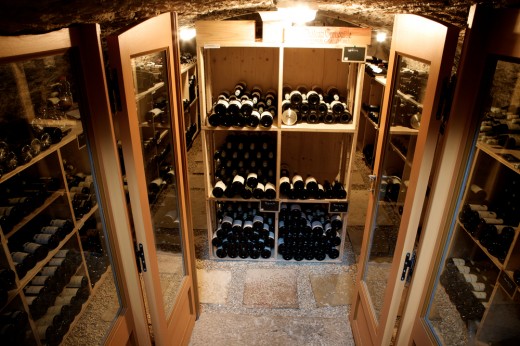 French doors open to a small wine cellar with an old world ambiance.