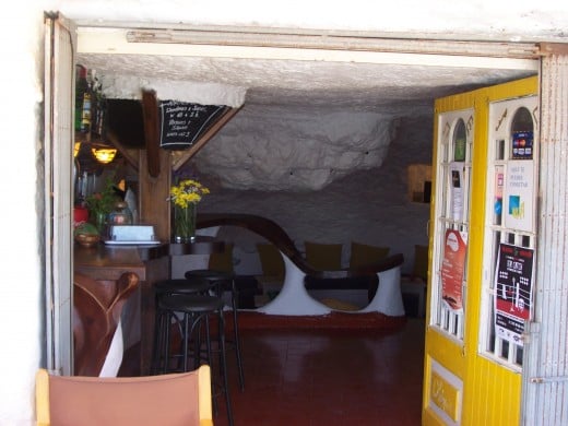 Looking inside of Chespir, an establishment carved into the rocks. There are others including shops.
