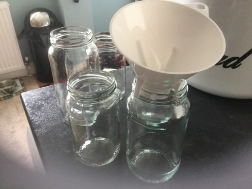 A scrubbed and sterilized old dishwasher salt filler works well as a funnel