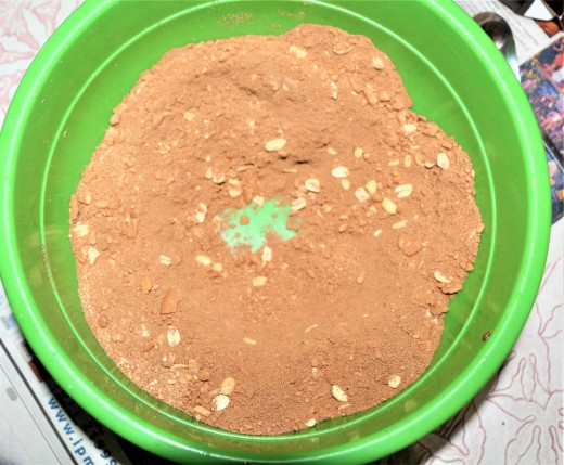 Making a well in the middle of the mix of dried ingredients.