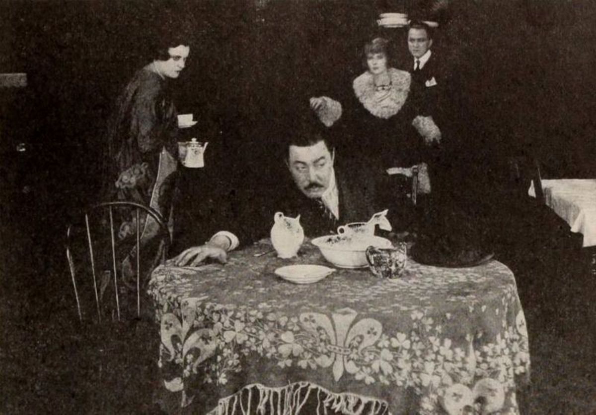 From Episode 10 of the silent film serial called "The Lightning Raider" in 1919. Warner Oland as Wu Fang (at the table), Pearl White and Henry G. Sell