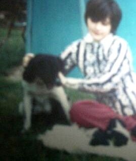 Kim with puppies, wearing THE SHIRT for approximately 5 minutes. Note the stiffness and discomfort due to sensory challenges and negative association.