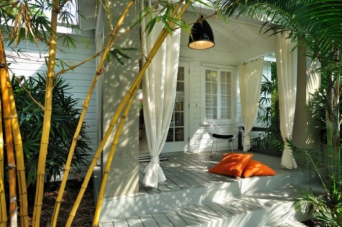 Flowing curtains on a porch add that tropical feel to your outdoor space.