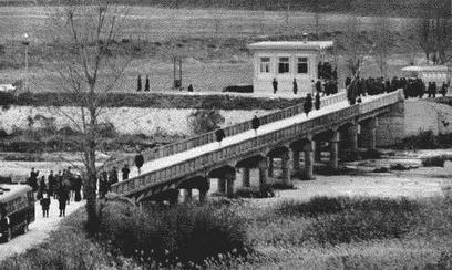 The USS Pueblo crew walking across The Bridge of No Return to freedom.