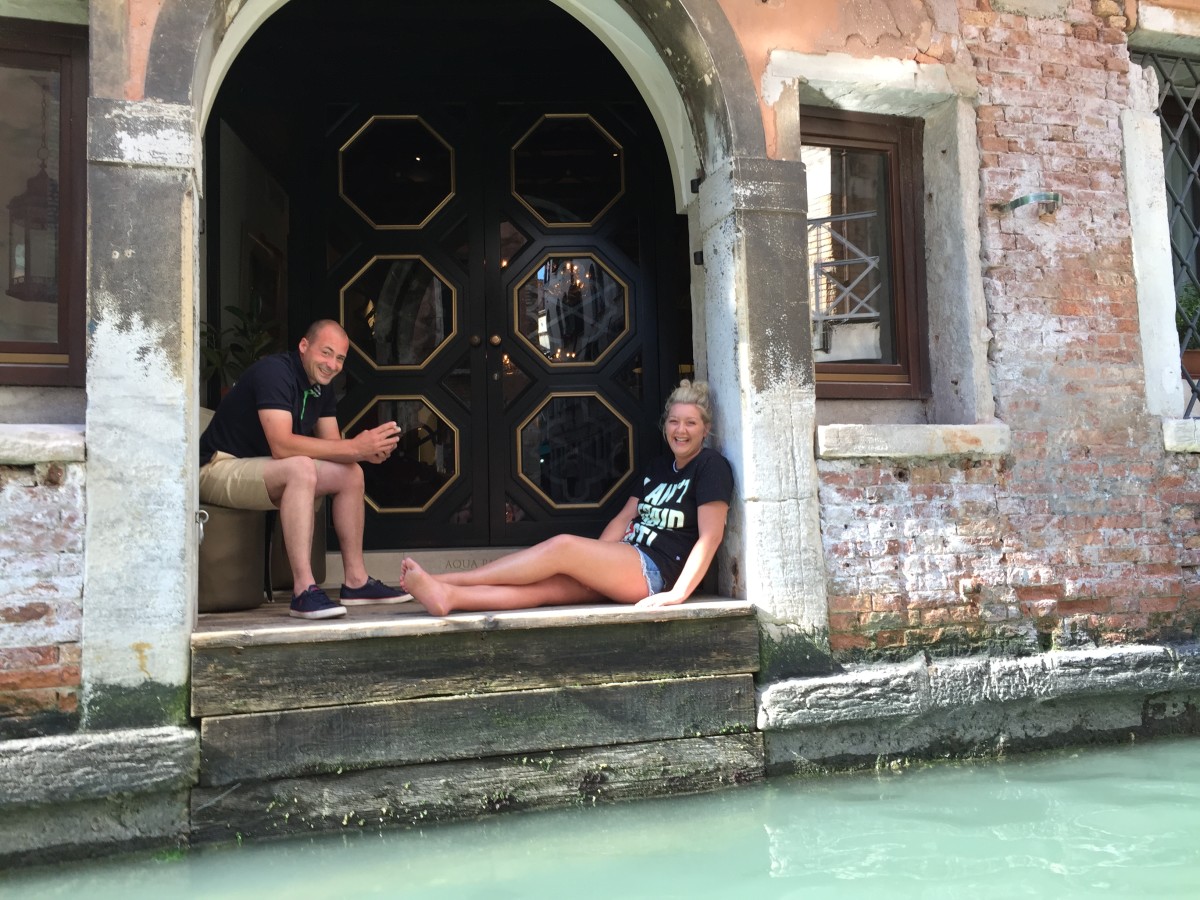 Two random people resting on a Venetian doorstep while we cruised by on our gondola. :)
