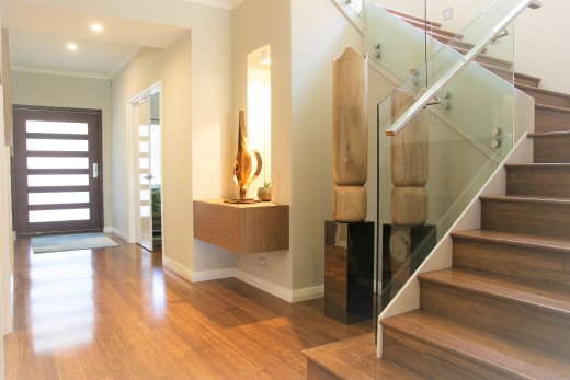 Ceiling down lights together with accent lights  enhance the space of this entrance hall