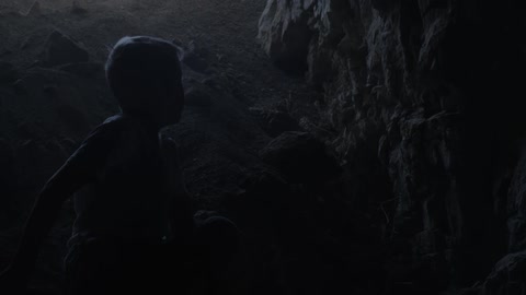 Boy walking through dark