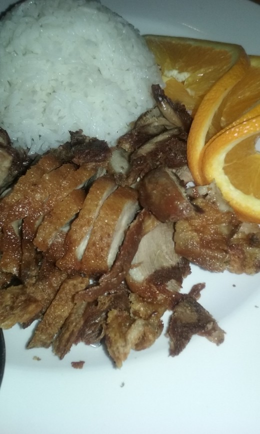 Roast duck with white rice and orange slices