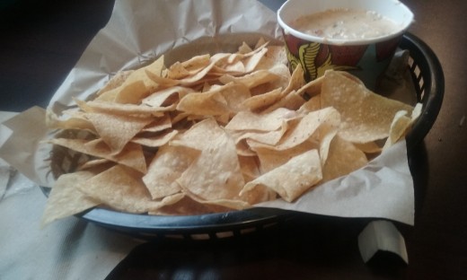 Comforting and filling hot queso cheese dip and nacho chips.