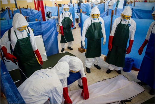 Health care workers learn how to properly dispose of the remains of a simulated patient who died from Ebola.