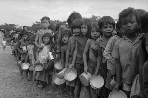 Refugee children wait for food outside Phnom Penh